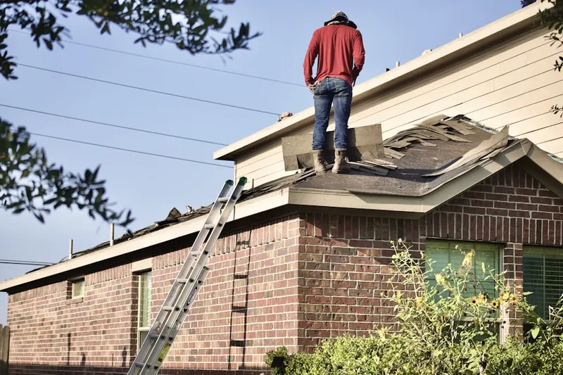 Professional roofer working on a residential roof in Stewartsville